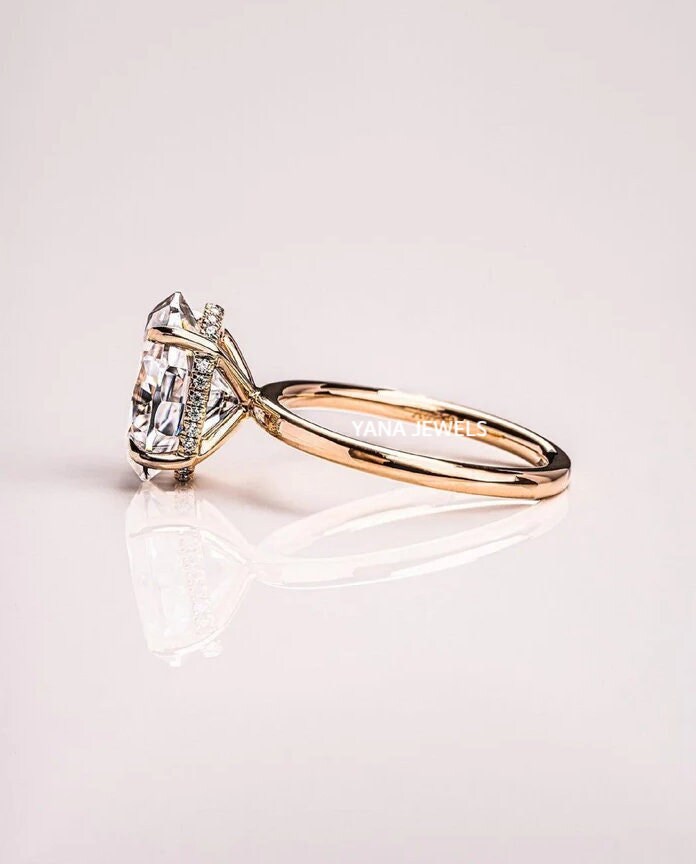 a close up of a diamond ring on a white surface