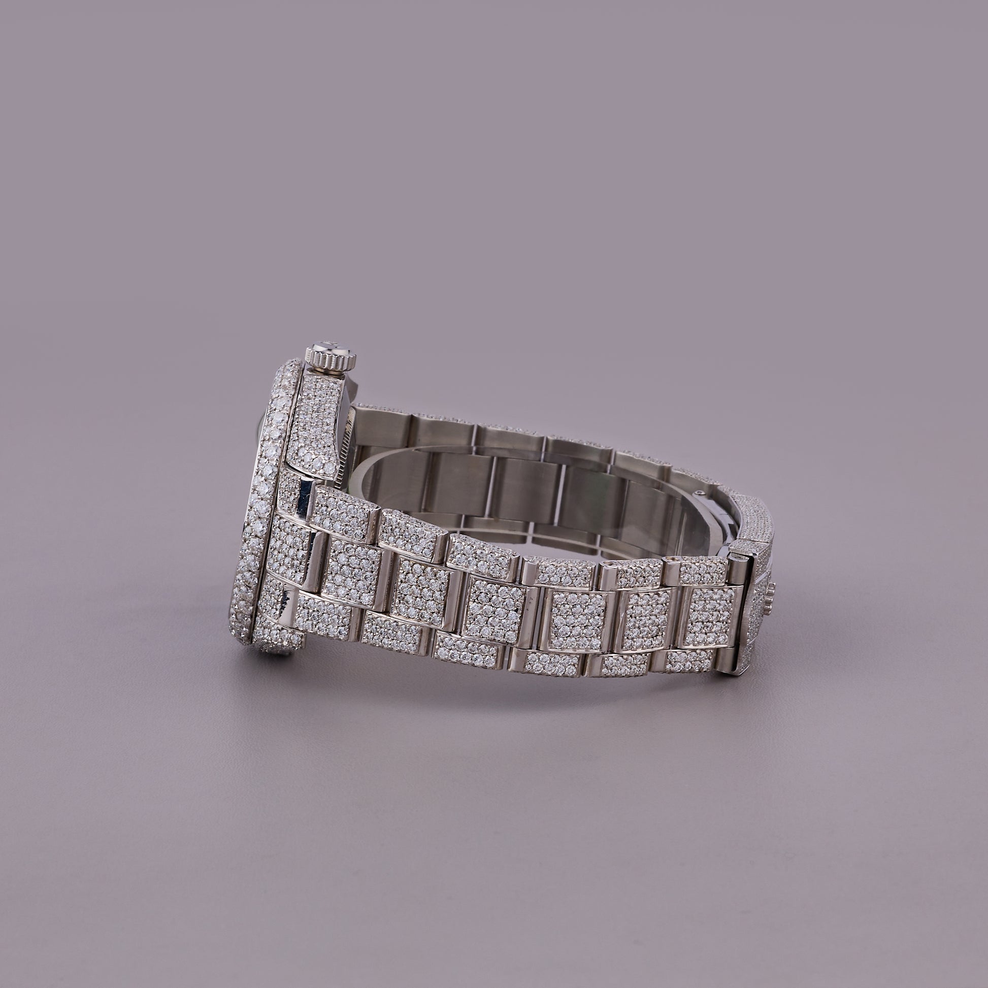 Silver bracelet with diamond accents on a gray background
