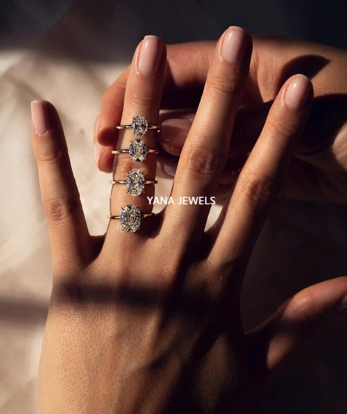 a woman&#39;s hand with three rings on it