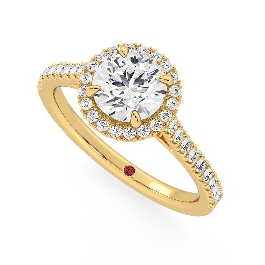 Round diamond centre and pavé diamond halo engagement ring set in 18ct yellow gold