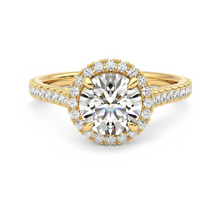 Round diamond centre and pavé diamond halo engagement ring set in 18ct yellow gold