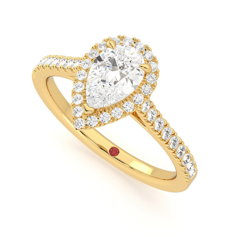 Pear diamond centre and pavé diamond halo engagement ring set in 18ct yellow gold