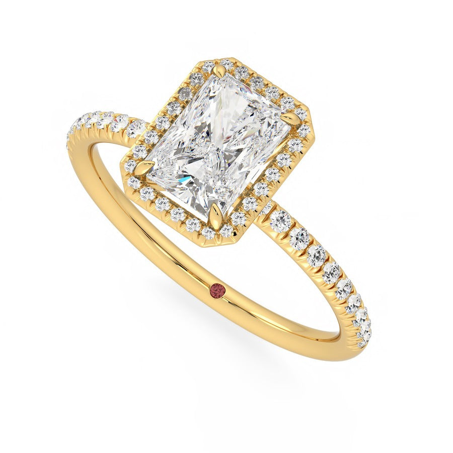 Radiant diamond centre and fishtail pavé diamond halo engagement ring set in 18ct yellow gold