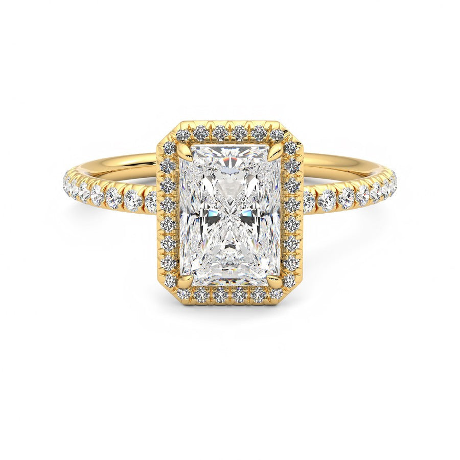 Radiant diamond centre and fishtail pavé diamond halo engagement ring set in 18ct yellow gold