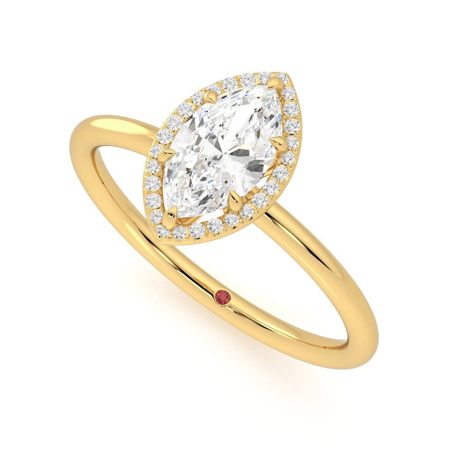 Marquise solitaire with pavé diamond halo engagement ring set in 18ct yellow gold