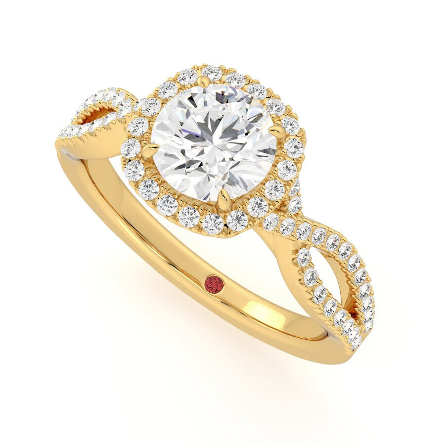 Round centre diamond and pavé diamond halo engagement ring set in 18ct yellow gold