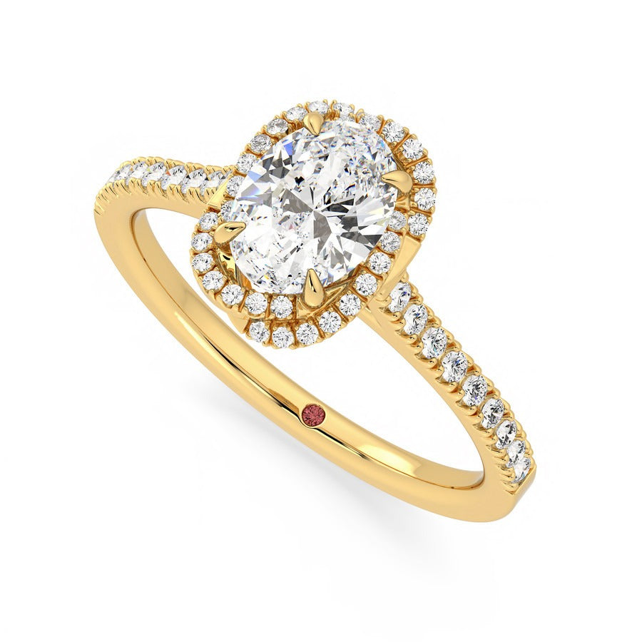 Oval diamond centre and twisted pavé diamond halo engagement ring set in 18ct yellow gold